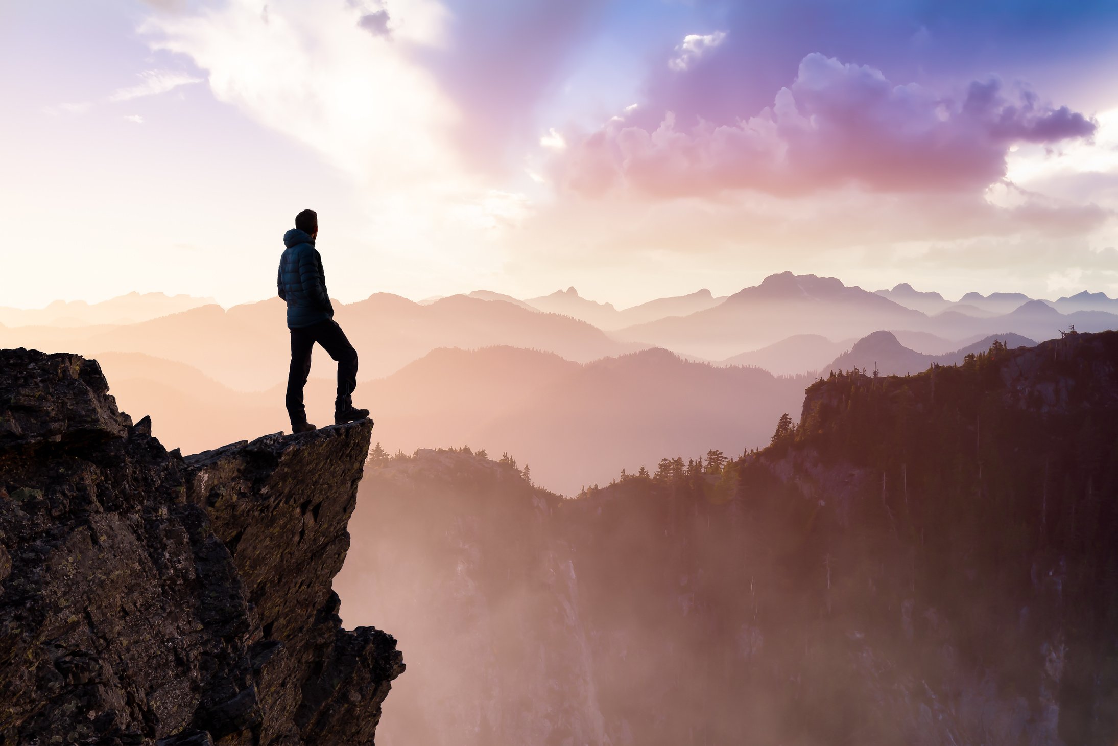 Man Hiker on Top of a Mountain Peak